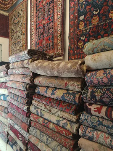 Folded rugs and wall-hung pieces on display